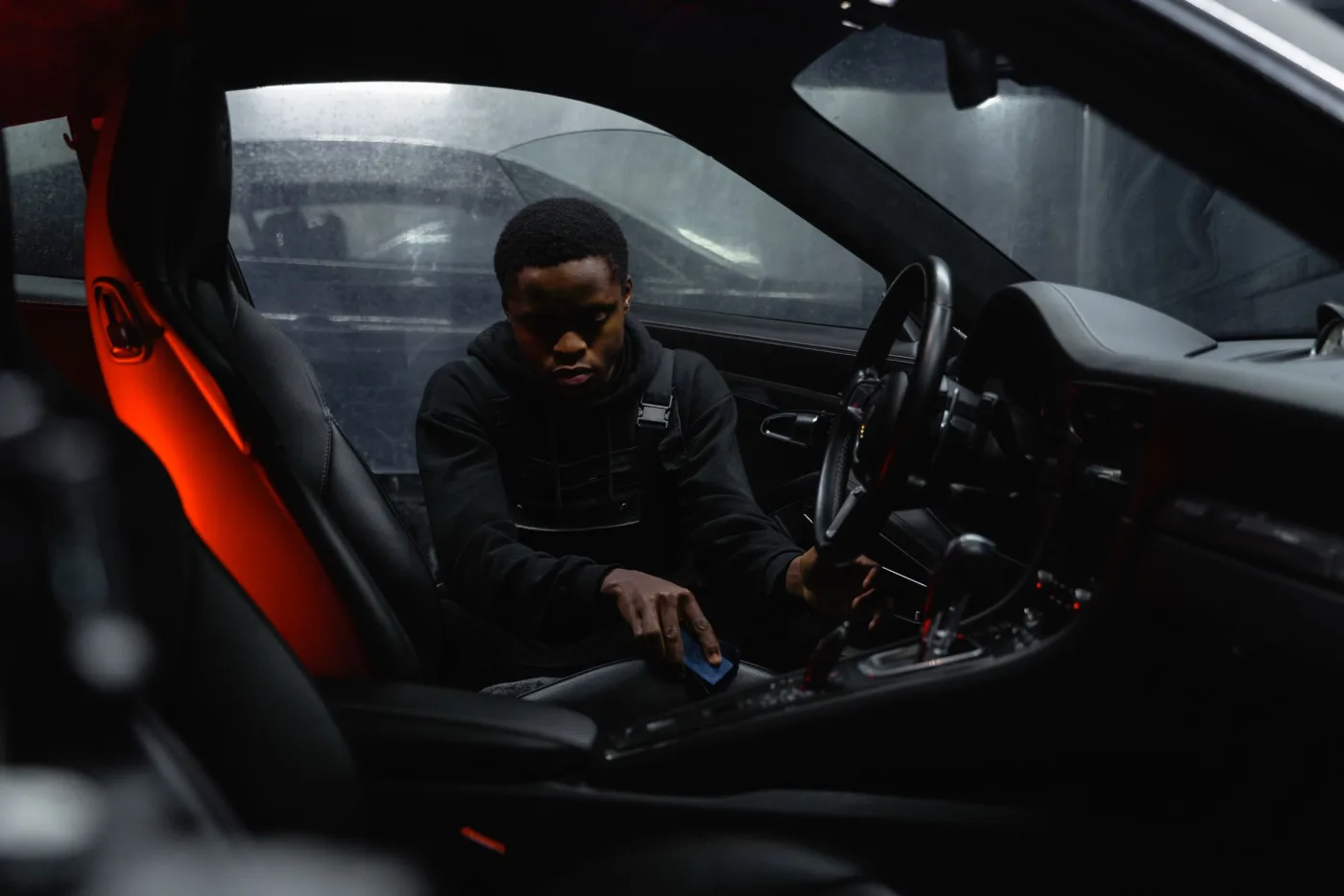 Detailer working carefully inside a vehicle